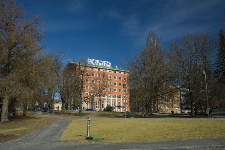 Grand Hotel Tammer surrounded by trees on a sunny day in Tampere, Finland