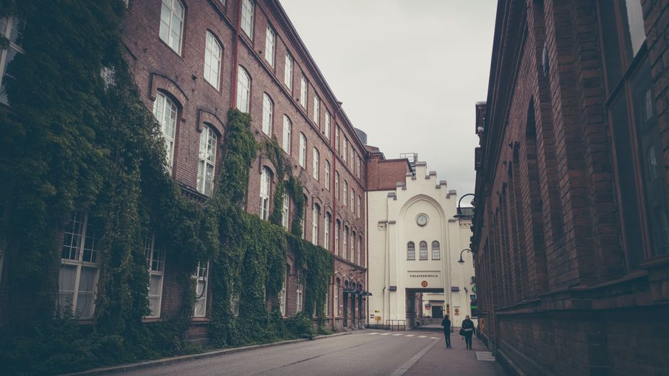Cozy street flanked by historic brick buildings in Tampere, Finland
