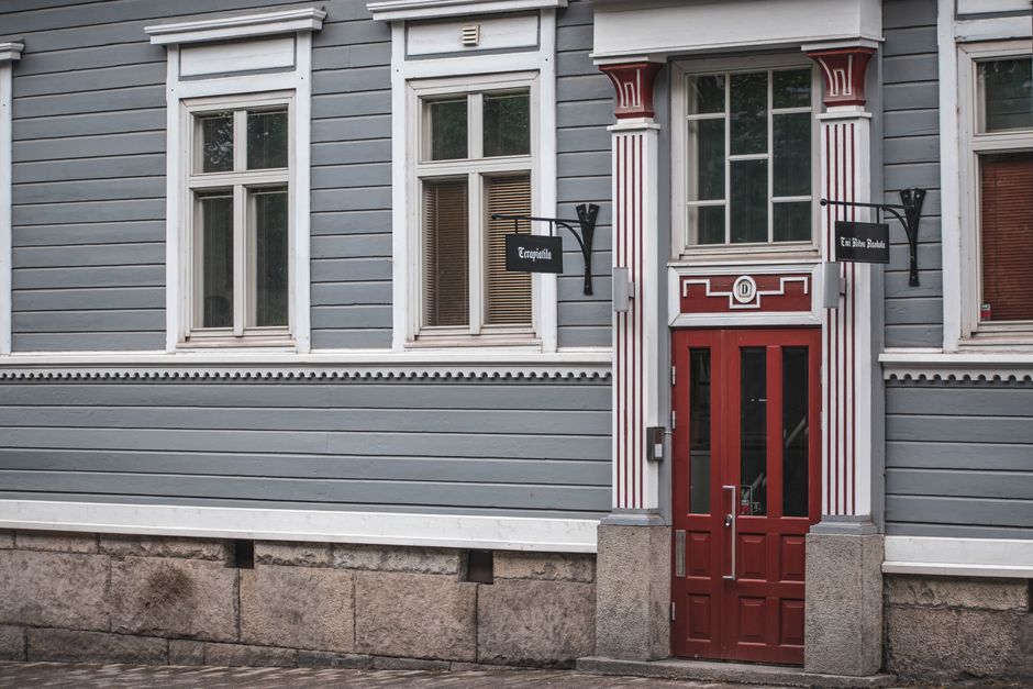Vintage building facade with red door in Tampere, Finland, classic Nordic architecture